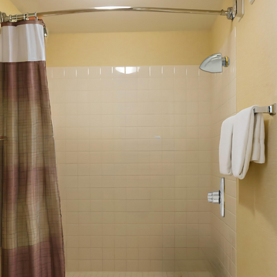 push button shower valve with anti-ligature shower head in a communal shower for temporary workers main