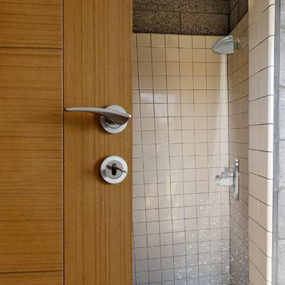 time and temperature adjustable push button shower valve with anti-ligature shower head in a communal shower for temporary workers main